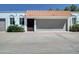 Wide view of charming exterior featuring a red tile roof, private garage, and stucco facade at 3401 N 37Th St # 14, Phoenix, AZ 85018