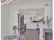 Open-concept kitchen with stainless steel appliances, white cabinetry, and light wood flooring at 3401 N 37Th St # 14, Phoenix, AZ 85018