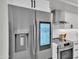 Modern stainless steel refrigerator with digital display complements the white kitchen cabinetry at 3401 N 37Th St # 14, Phoenix, AZ 85018