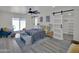 Bright bedroom boasts gray wood-look floors, slider to back patio, barn-door closet, and modern ceiling fan at 3401 N 37Th St # 14, Phoenix, AZ 85018