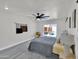 Bright bedroom boasts gray wood-look floors, slider to back patio, and modern ceiling fan at 3401 N 37Th St # 14, Phoenix, AZ 85018