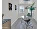 Bright office space featuring a modern glass desk, decorative lighting, and neutral wall paint at 3401 N 37Th St # 14, Phoenix, AZ 85018