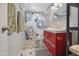 Stylish bathroom featuring a red vanity, patterned tile, and modern fixtures at 3701 E Karen Dr, Phoenix, AZ 85032
