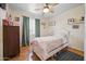 Cozy bedroom with hardwood floors, a bed with colorful bedding, and natural light at 3701 E Karen Dr, Phoenix, AZ 85032