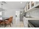 Open kitchen featuring white cabinets, stainless appliances, and a dining area with seating at 3701 E Karen Dr, Phoenix, AZ 85032