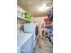 Functional laundry room with modern washer and dryer units and ample storage shelves at 3701 E Karen Dr, Phoenix, AZ 85032