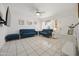 Inviting living room with tile flooring, blue sofas, and a ceiling fan at 3701 E Karen Dr, Phoenix, AZ 85032