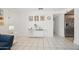 View into living room with white walls, blue chair and view to the kitchen area at 3701 E Karen Dr, Phoenix, AZ 85032
