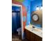 Fun themed bathroom with blue walls, sink, and a quirky porthole style mirror at 4018 E Adobe Dr, Phoenix, AZ 85050