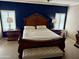 Primary bedroom featuring a large wooden bed frame, neutral carpet, and plantation shutters at 4018 E Adobe Dr, Phoenix, AZ 85050