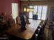 Dining room featuring a dark wood table with seating for eight and shuttered windows at 4018 E Adobe Dr, Phoenix, AZ 85050