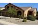 Landscaped desert-style yard with mature trees and shrubbery in front of a two-story home at 4018 E Adobe Dr, Phoenix, AZ 85050