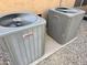 Image shows two modern Lennox AC units situated on a gravel bed next to the house at 4018 E Adobe Dr, Phoenix, AZ 85050