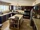 Kitchen featuring a center island, tile floors, dark cabinets and stainless steel appliances at 4018 E Adobe Dr, Phoenix, AZ 85050