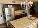 Kitchen featuring stainless steel refrigerator and a center island with granite countertops at 4018 E Adobe Dr, Phoenix, AZ 85050