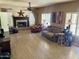 Bright living room featuring wood-look floors, fireplace, and large windows with shutters at 4018 E Adobe Dr, Phoenix, AZ 85050