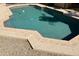 Backyard swimming pool with a stone trimmed concrete surround and gravel landscape at 4018 E Adobe Dr, Phoenix, AZ 85050