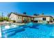 Beautiful backyard with a pool, covered patio, basketball court, lush landscaping, and lounge chairs at 4021 E Glenrosa Ave, Phoenix, AZ 85018