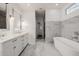 Luxurious bathroom featuring marble countertops, floors, and a soaking tub at 4021 E Glenrosa Ave, Phoenix, AZ 85018