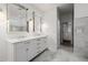 Bright bathroom featuring double vanities, marble floors, and bathtub at 4021 E Glenrosa Ave, Phoenix, AZ 85018