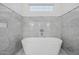 Freestanding tub with marble accents in bright bathroom at 4021 E Glenrosa Ave, Phoenix, AZ 85018