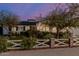 Charming single-story home featuring a well-manicured front yard and a brick and white picket fence at 4021 E Glenrosa Ave, Phoenix, AZ 85018