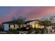 Charming home featuring a cozy brick fireplace, green landscaping, and a brick and white wood fence at 4021 E Glenrosa Ave, Phoenix, AZ 85018