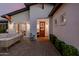 Inviting front entrance with a beautiful wood door and brick pathway with outdoor seating at 4021 E Glenrosa Ave, Phoenix, AZ 85018