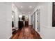 Hallway with dark hardwood floors, brick accent wall, and decorative mirror at 4021 E Glenrosa Ave, Phoenix, AZ 85018