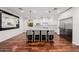 Bright kitchen features hardwood floors, stainless appliances, marble countertops, and a kitchen island with seating at 4021 E Glenrosa Ave, Phoenix, AZ 85018
