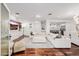Spacious living room with a large white sofa, hardwood floors, and recessed lighting at 4021 E Glenrosa Ave, Phoenix, AZ 85018
