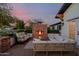 Cozy outdoor seating area with a brick fireplace, couches, and a coffee table at 4021 E Glenrosa Ave, Phoenix, AZ 85018
