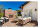 Outdoor fireplace with wicker seating and brick patio at 4021 E Glenrosa Ave, Phoenix, AZ 85018