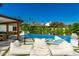 Inviting pool with luxurious lounge seating, lush landscaping, and a view of the covered outdoor dining area at 4021 E Glenrosa Ave, Phoenix, AZ 85018