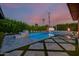 Backyard pool featuring a sundeck with fire bowls and artificial turf at 4021 E Glenrosa Ave, Phoenix, AZ 85018