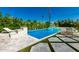 A modern pool with sleek, geometric design complemented by chic lounge chairs and lush greenery at 4021 E Glenrosa Ave, Phoenix, AZ 85018