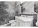 Elegant powder room featuring nature wallpaper and marble vanity at 4021 E Glenrosa Ave, Phoenix, AZ 85018