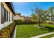 Lush green backyard featuring an outdoor brick fireplace and manicured landscaping at 4021 E Glenrosa Ave, Phoenix, AZ 85018
