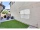 Relaxing backyard featuring artificial grass, a seating area, and a grill, great for outdoor activities at 4046 S 58Th Ln, Phoenix, AZ 85043