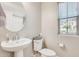 Comfortable bathroom with pedestal sink, window, and toilet at 4046 S 58Th Ln, Phoenix, AZ 85043