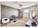 Bedroom featuring modern vanity area with chair, decorative wall accents, and a ceiling fan at 4046 S 58Th Ln, Phoenix, AZ 85043