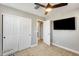 Neutral bedroom featuring carpet flooring, fan, and large closet at 4046 S 58Th Ln, Phoenix, AZ 85043