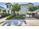 Charming two-story home featuring a manicured front yard with vibrant flowers and lush landscaping at 4046 S 58Th Ln, Phoenix, AZ 85043