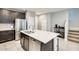 Contemporary kitchen with stainless steel appliances, an island with seating, and dark wood cabinets at 4046 S 58Th Ln, Phoenix, AZ 85043