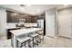 Well-equipped kitchen featuring stainless steel appliances, a center island with seating, and modern finishes at 4046 S 58Th Ln, Phoenix, AZ 85043