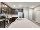 Modern kitchen boasting stainless steel appliances, a large island, and sleek, dark cabinetry at 4046 S 58Th Ln, Phoenix, AZ 85043