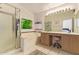 Well-lit bathroom with double sink vanity, tub and walk-in shower at 4441 E Desert Wind Dr, Phoenix, AZ 85044