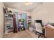 Neutral bedroom with shelves, desk, white chair, and natural light at 4441 E Desert Wind Dr, Phoenix, AZ 85044