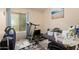 Bedroom with a treadmill, artwork, and a compact seating area at 4441 E Desert Wind Dr, Phoenix, AZ 85044