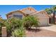 Front exterior featuring desert landscaping and a two-car garage at 4441 E Desert Wind Dr, Phoenix, AZ 85044
